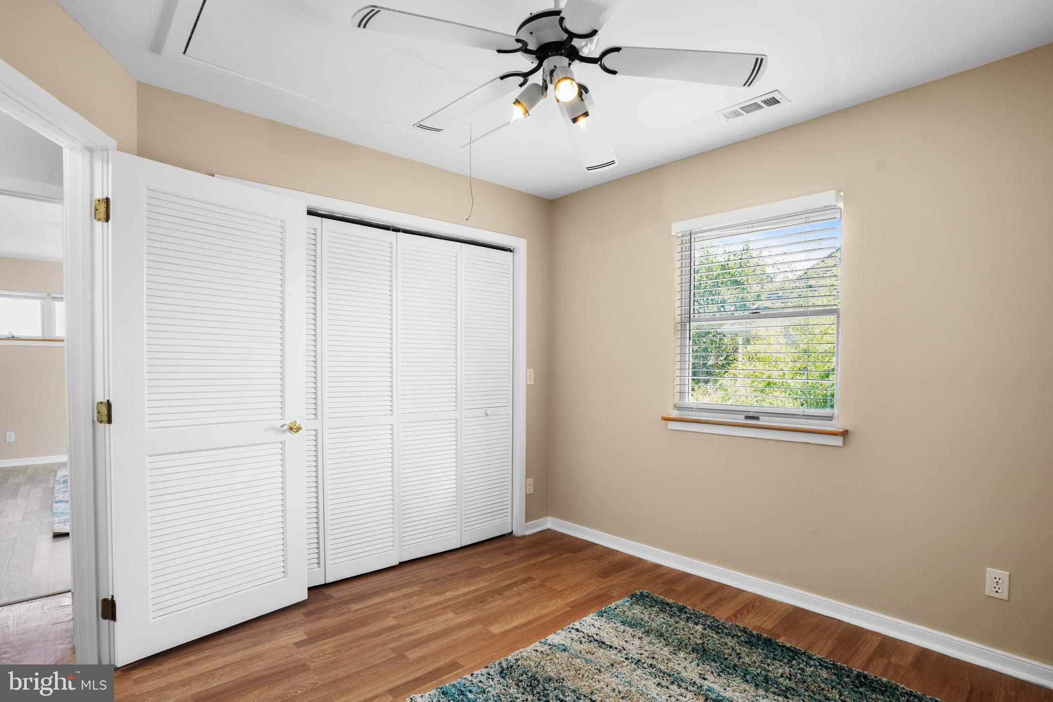 4734 Oak Road Shady Side, MD 20764 - Photo 26 of 48 a view of an empty room with wooden floor and a window