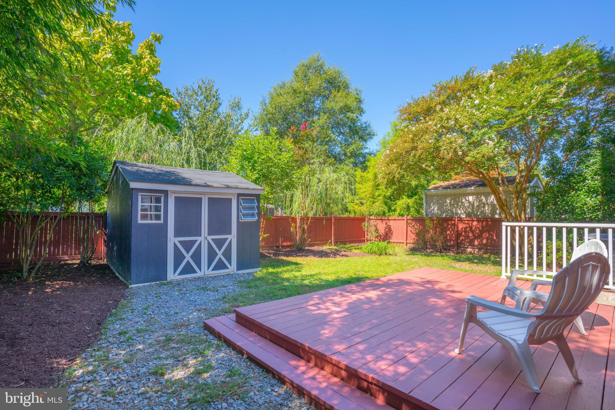 4734 Oak Road Shady Side, MD 20764 - Photo 37 of 48 a view of a backyard with table and chairs and a yard