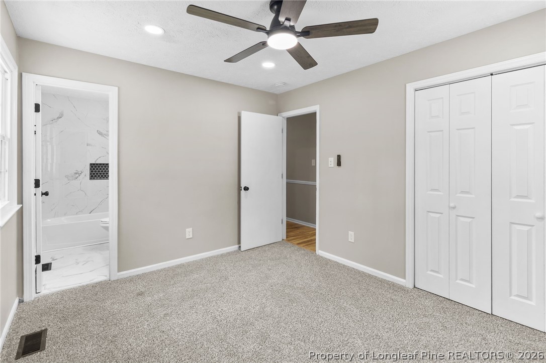 402 Gainey Road Raeford, NC 28376 - Photo 14 of 30 an empty room with closet and a chandelier fan