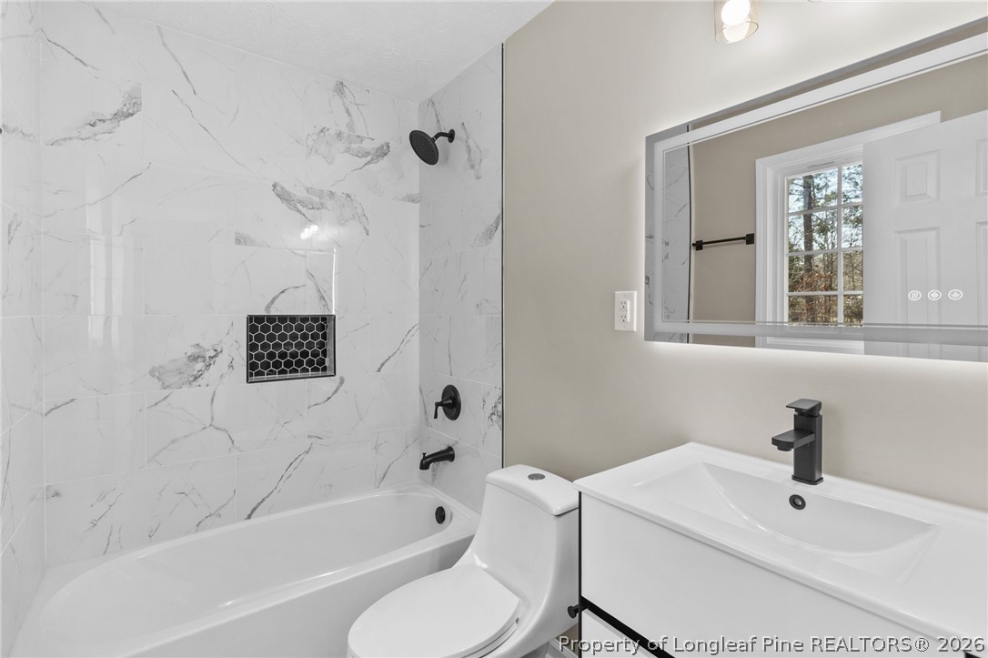 402 Gainey Road Raeford, NC 28376 - Photo 15 of 30 a bathroom with a sink a toilet and a bathtub