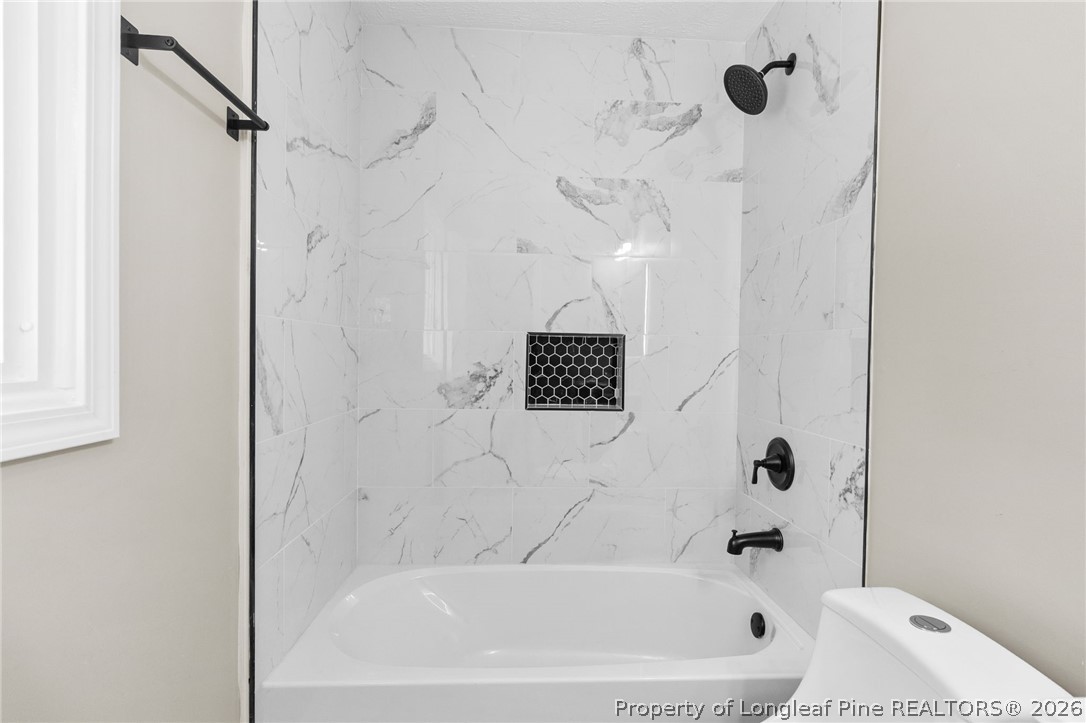 402 Gainey Road Raeford, NC 28376 - Photo 17 of 30 a bathroom with a bathtub and a shower