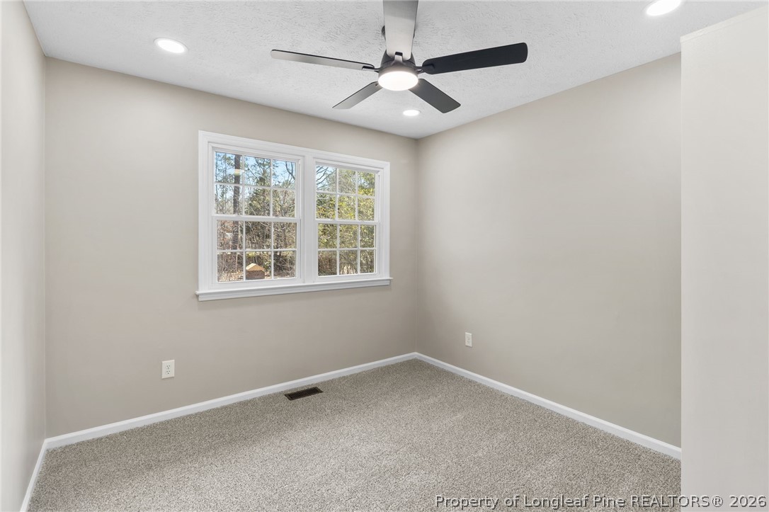 402 Gainey Road Raeford, NC 28376 - Photo 23 of 30 an empty room with windows and fan