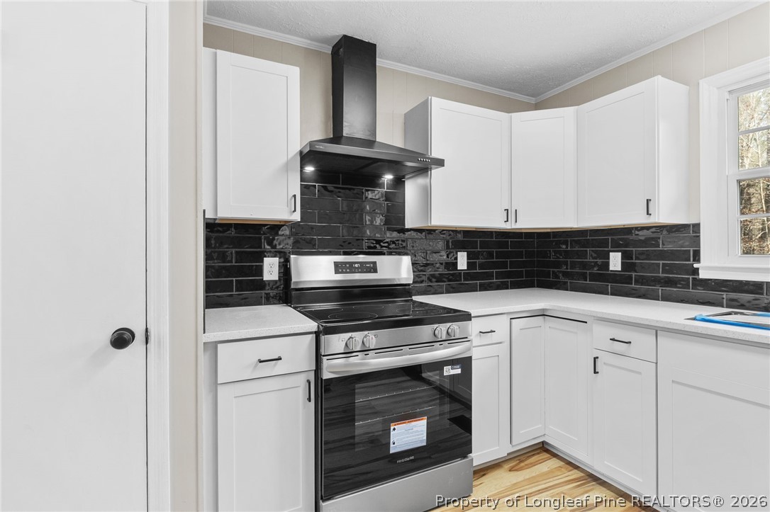 402 Gainey Road Raeford, NC 28376 - Photo 8 of 30 a kitchen with stainless steel appliances granite countertop a stove a sink and white cabinets