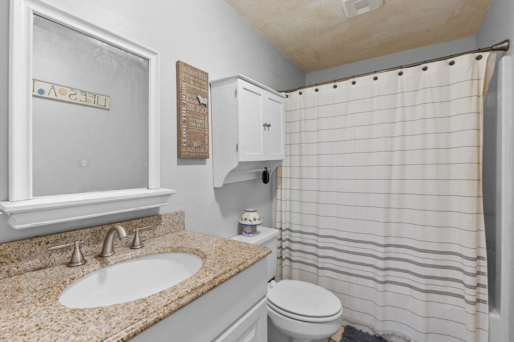 300 Falmouth Road, Unit 20D Mashpee, MA 02649 - Photo 12 of 20 a bathroom with a granite countertop sink toilet and shower
