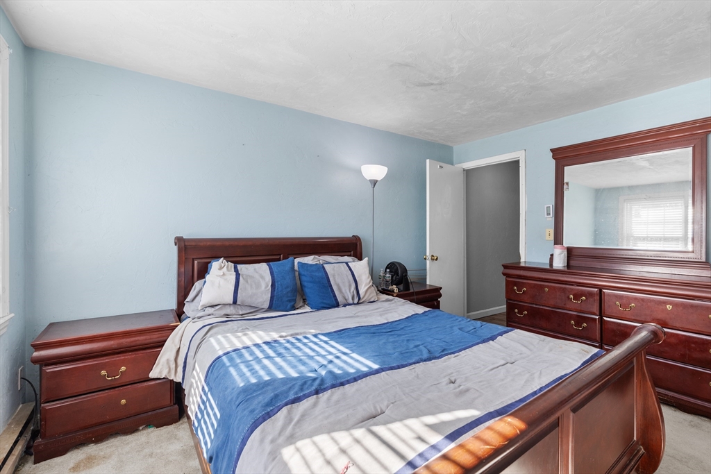 300 Falmouth Road, Unit 20D Mashpee, MA 02649 - Photo 13 of 20 a bed room with a bed and a dresser
