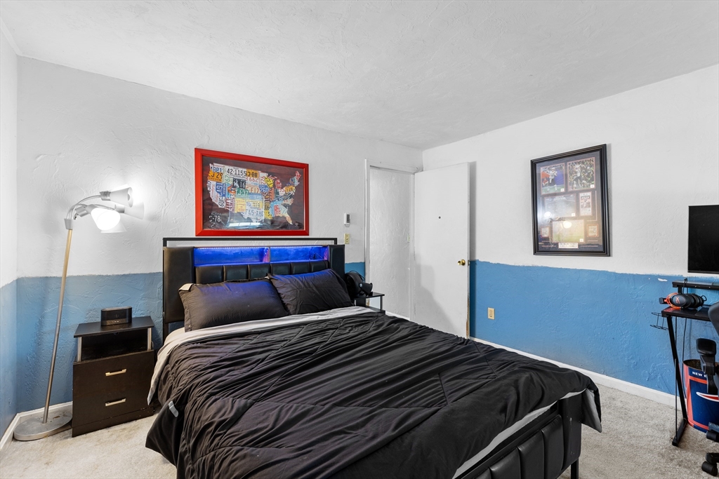 300 Falmouth Road, Unit 20D Mashpee, MA 02649 - Photo 14 of 20 a bedroom with a bed and a painting on the wall
