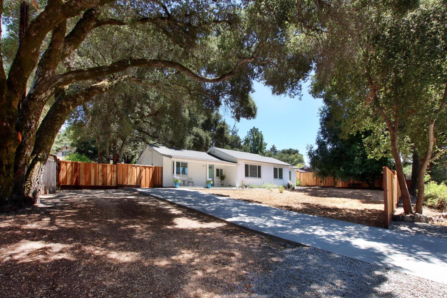 a view of a house with backyard and sitting area
