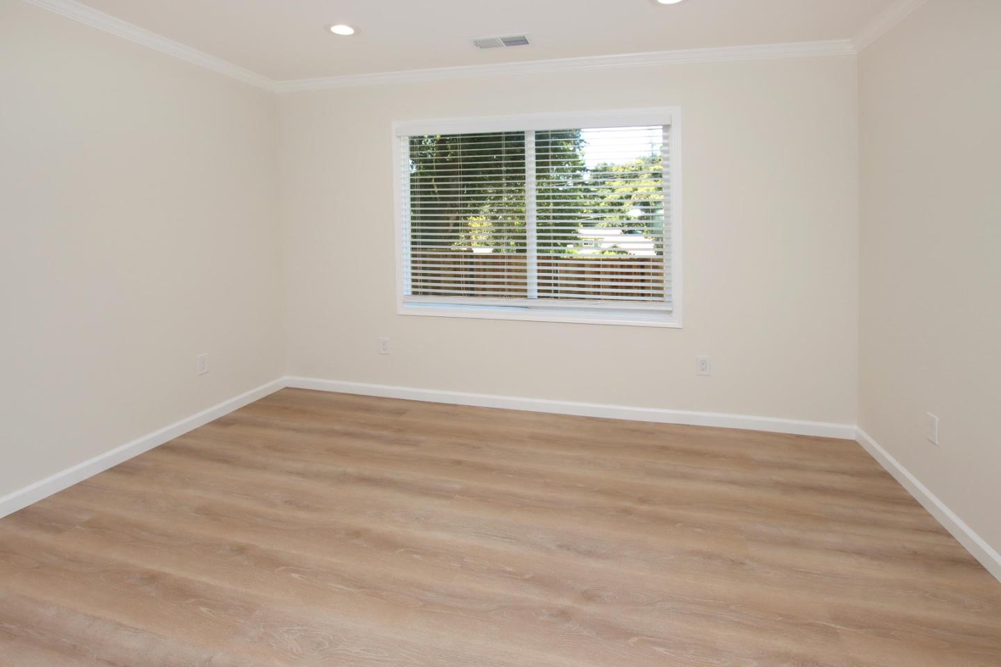 9260 Glen Arbor Road Ben Lomond, CA 95005 - Photo 12 of 33 a view of an empty room with wooden floor and a window