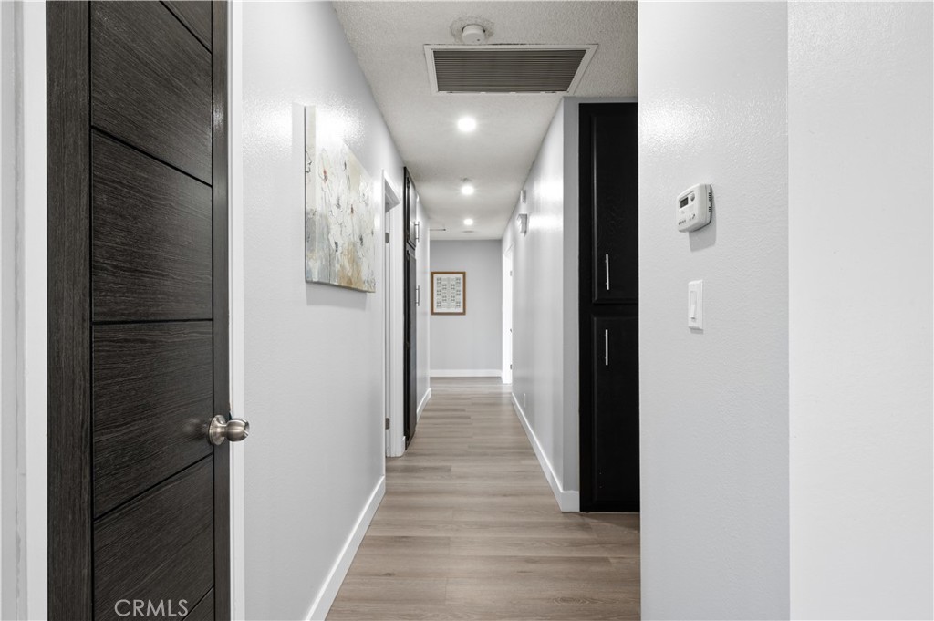 18561 Bert Road Riverside, CA 92508 - Photo 25 of 72 a view of a hallway with wooden floor