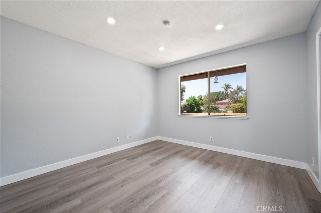 18561 Bert Road Riverside, CA 92508 - Photo 30 of 72 a view of an empty room with wooden floor and a window