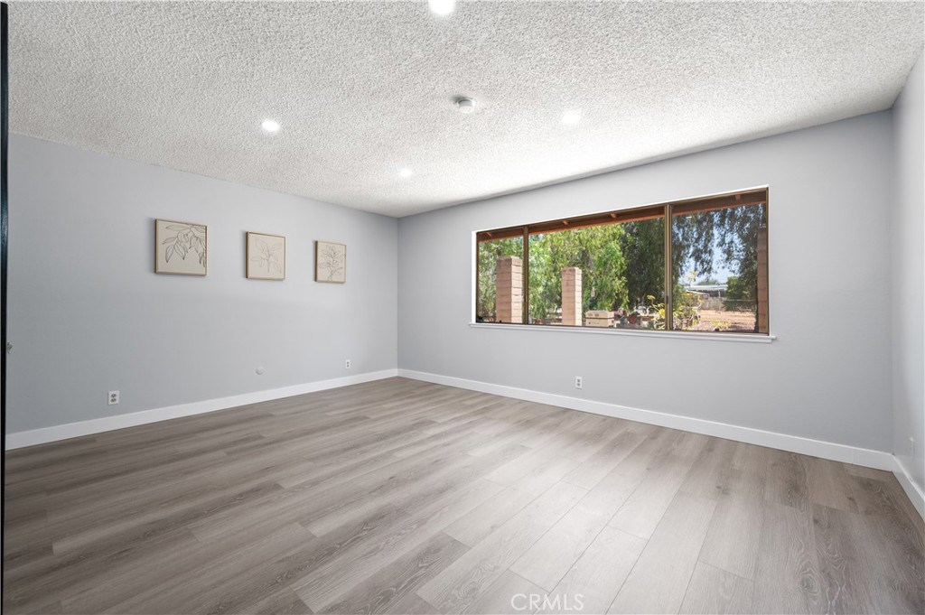 18561 Bert Road Riverside, CA 92508 - Photo 34 of 72 a view of an empty room with wooden floor and a window