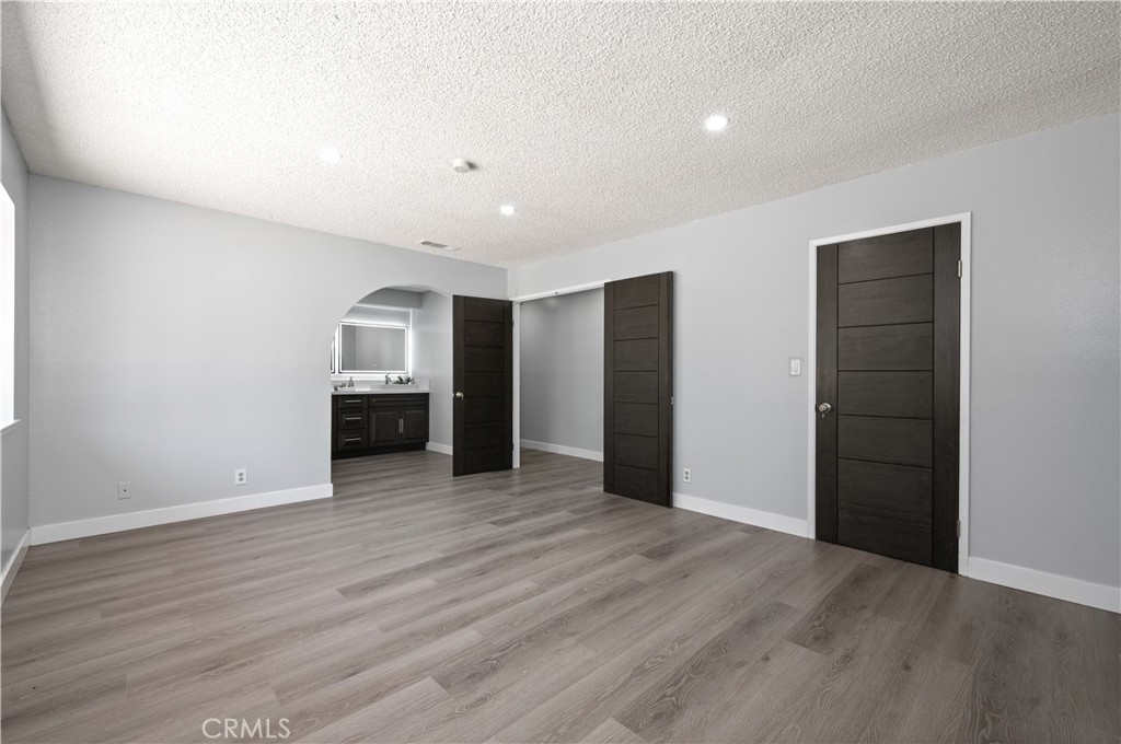 18561 Bert Road Riverside, CA 92508 - Photo 35 of 72 a view of an empty room with closet and wooden floor