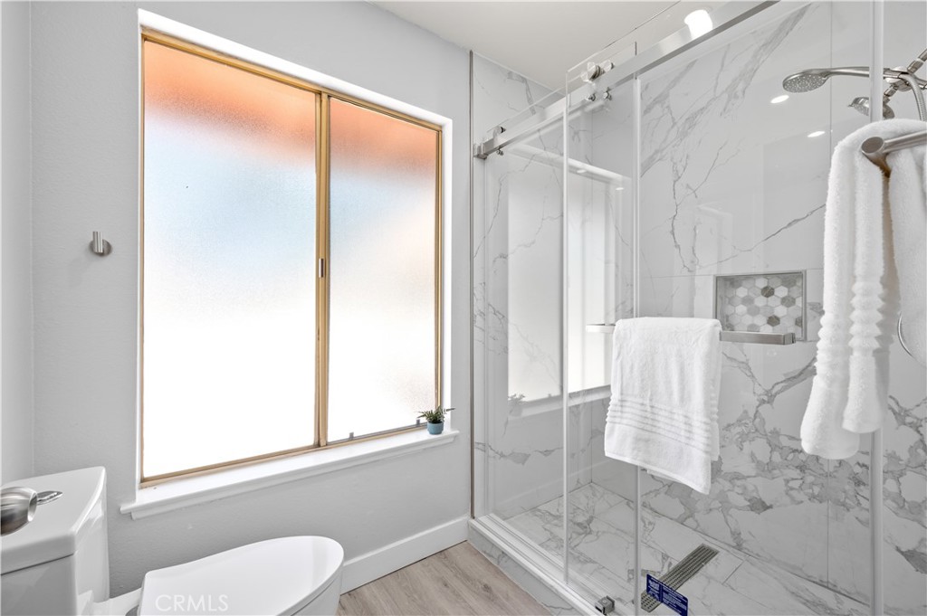 18561 Bert Road Riverside, CA 92508 - Photo 40 of 72 a bathroom with a shower and a toilet