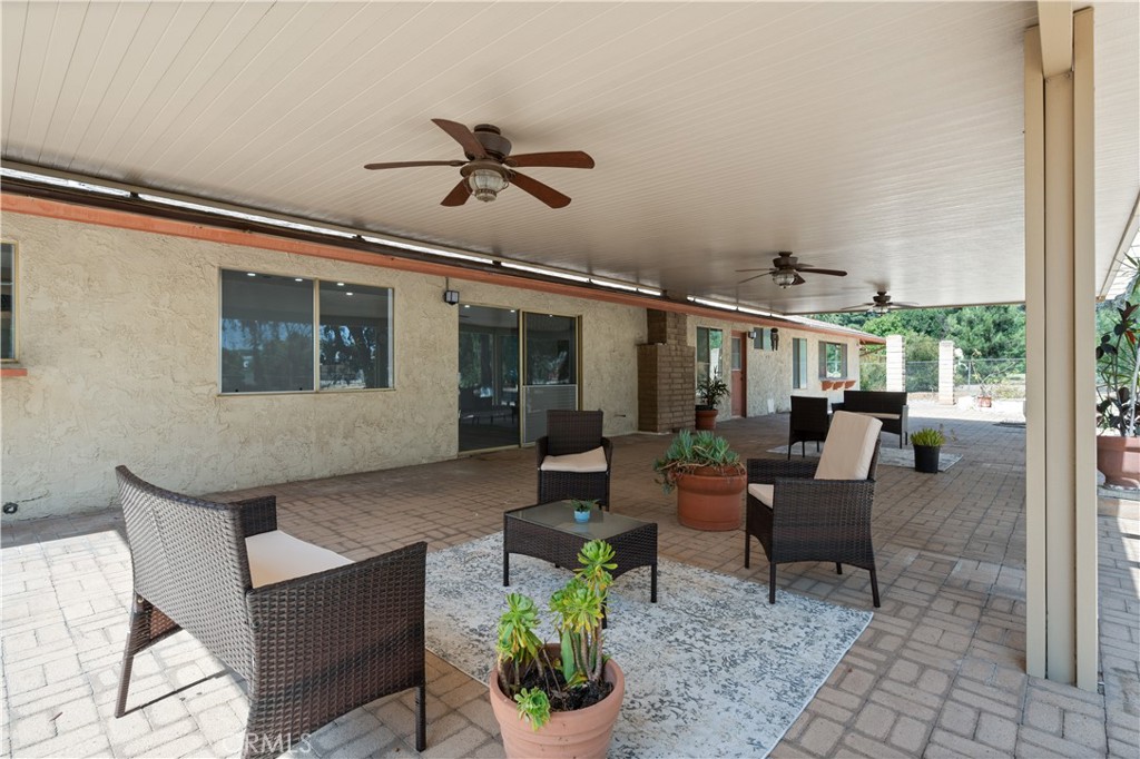 18561 Bert Road Riverside, CA 92508 - Photo 47 of 72 a outdoor space with patio the couches and a dining table with the potted plants