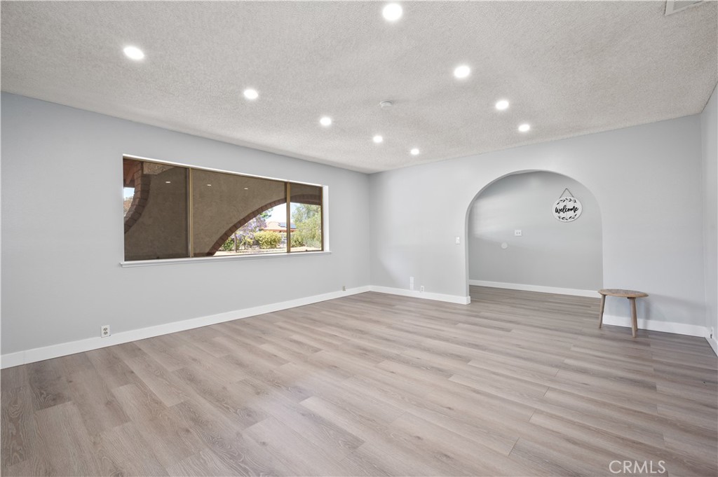 18561 Bert Road Riverside, CA 92508 - Photo 9 of 72 a view of an empty room with wooden floor and a window
