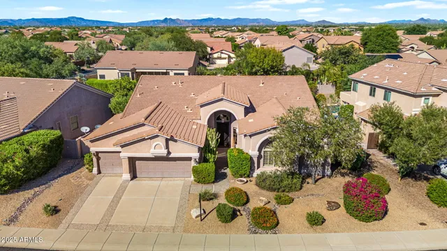 an aerial view of a house with yard