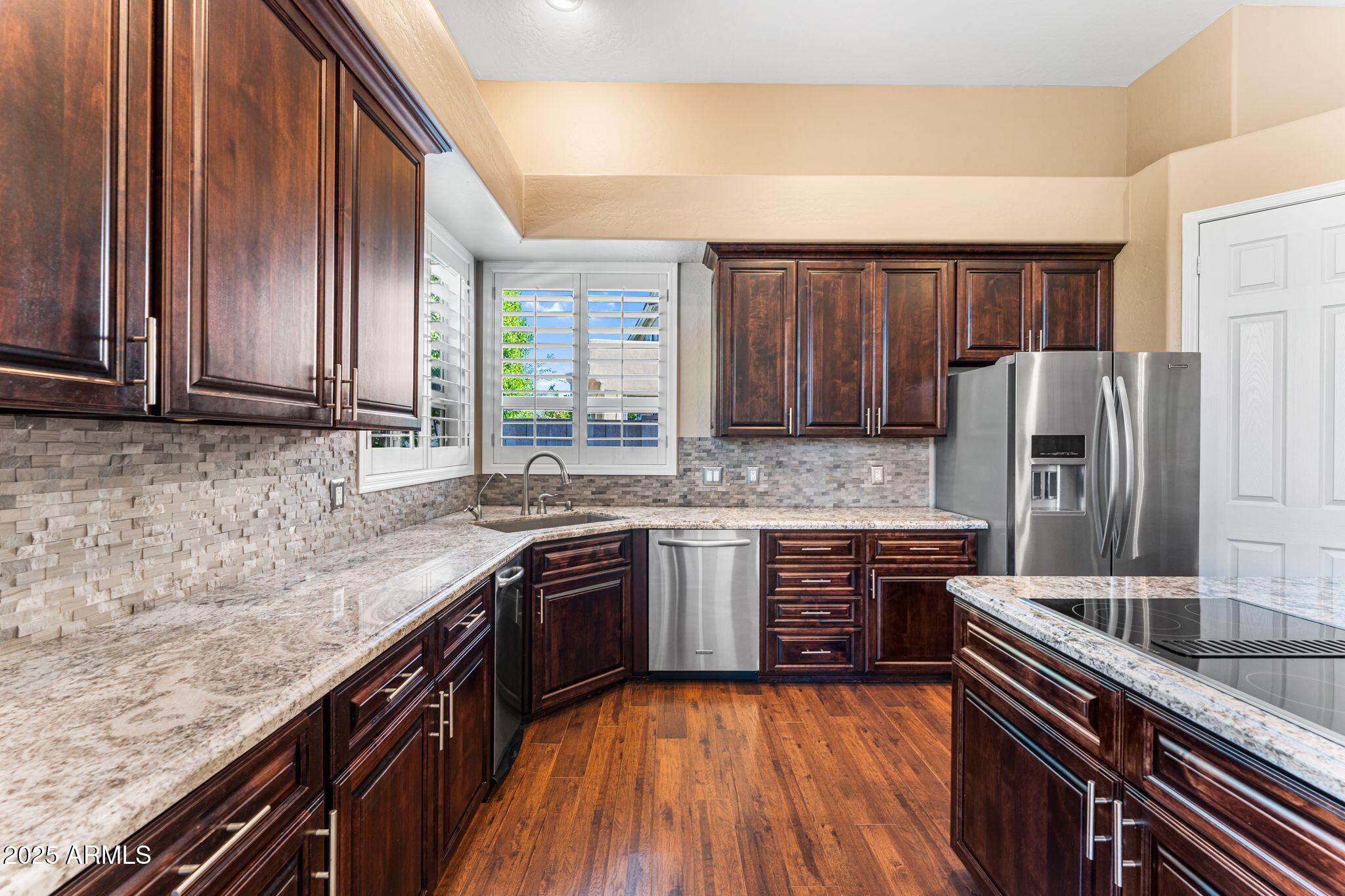4410 East Robin Lane Phoenix, AZ 85050 - Photo 12 of 44 a kitchen with stainless steel appliances granite countertop a sink stove and refrigerator