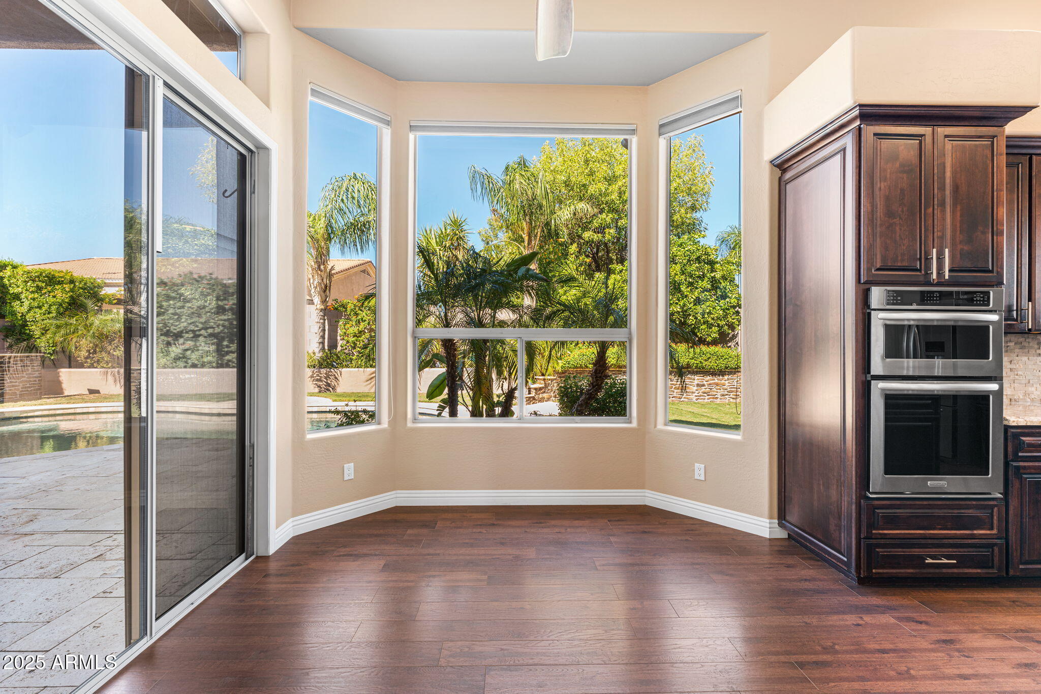 4410 East Robin Lane Phoenix, AZ 85050 - Photo 13 of 44 a view of an empty room with wooden floor and a window