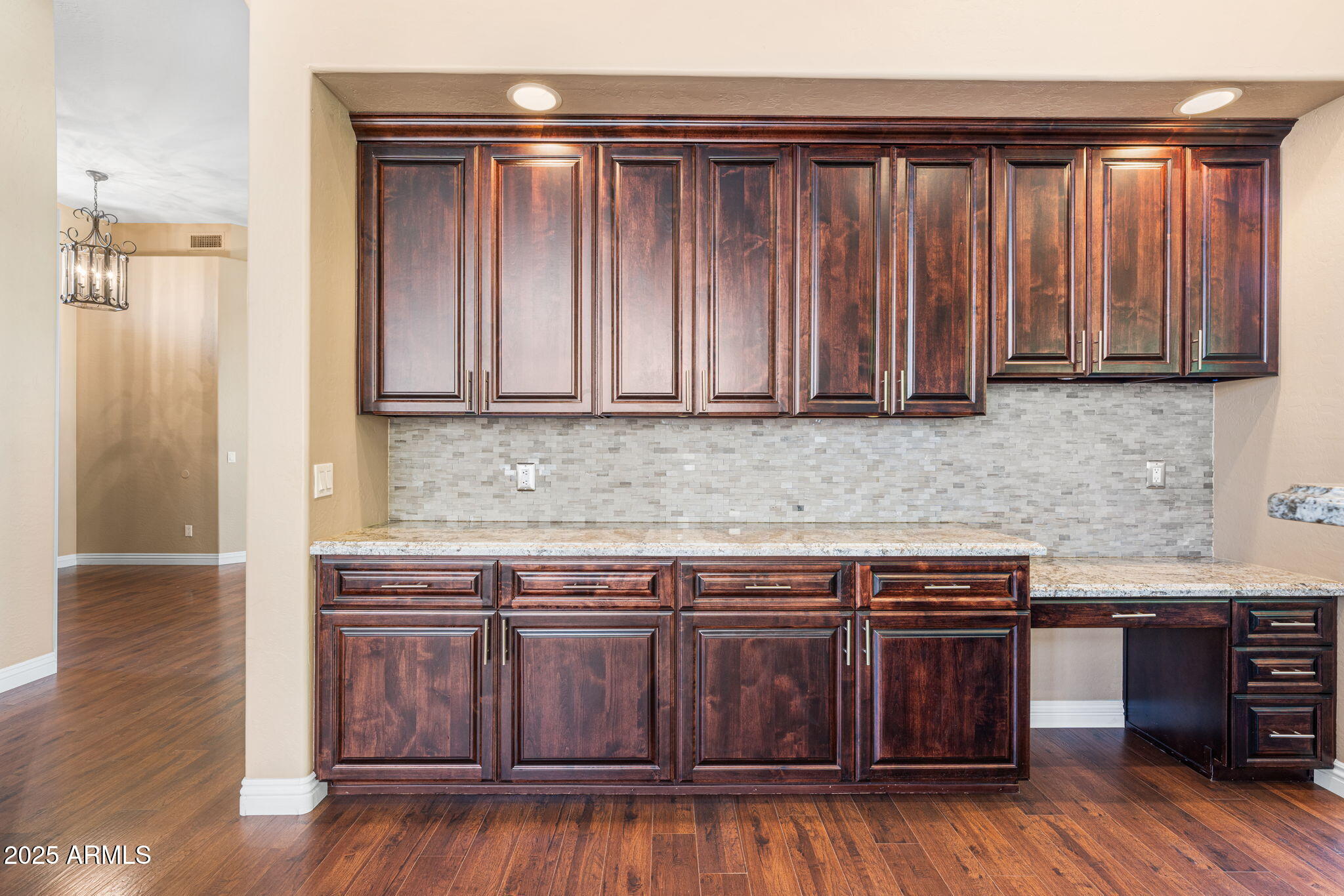 4410 East Robin Lane Phoenix, AZ 85050 - Photo 14 of 44 a kitchen with granite countertop wooden cabinets and a wooden floor