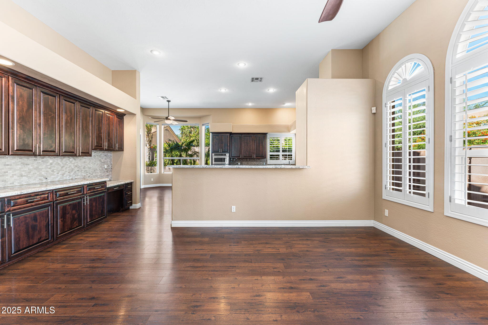 4410 East Robin Lane Phoenix, AZ 85050 - Photo 16 of 44 a large kitchen with stainless steel appliances granite countertop a stove a sink a refrigerator and a large window