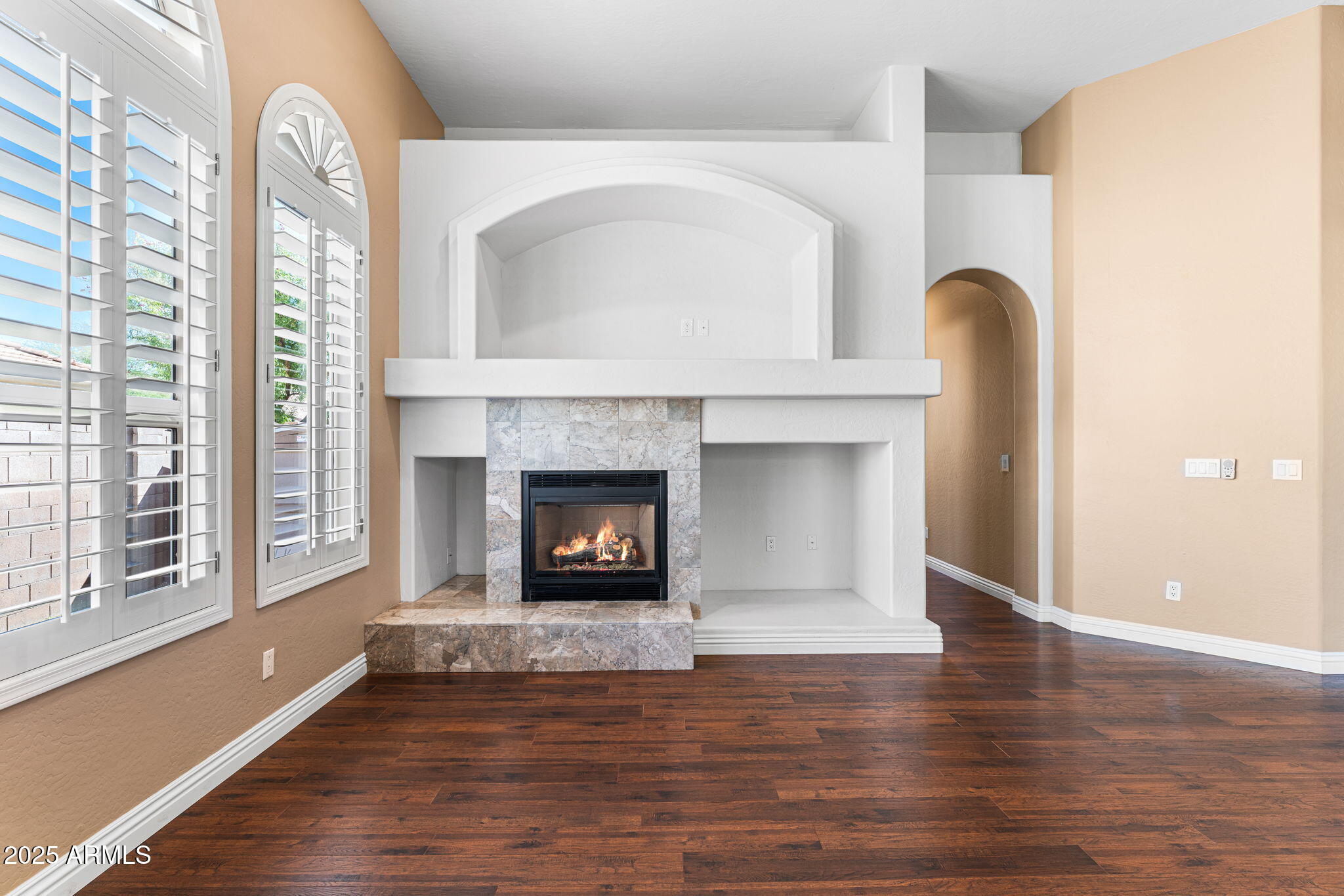 4410 East Robin Lane Phoenix, AZ 85050 - Photo 17 of 44 a living room with a fireplace with a wooden floor