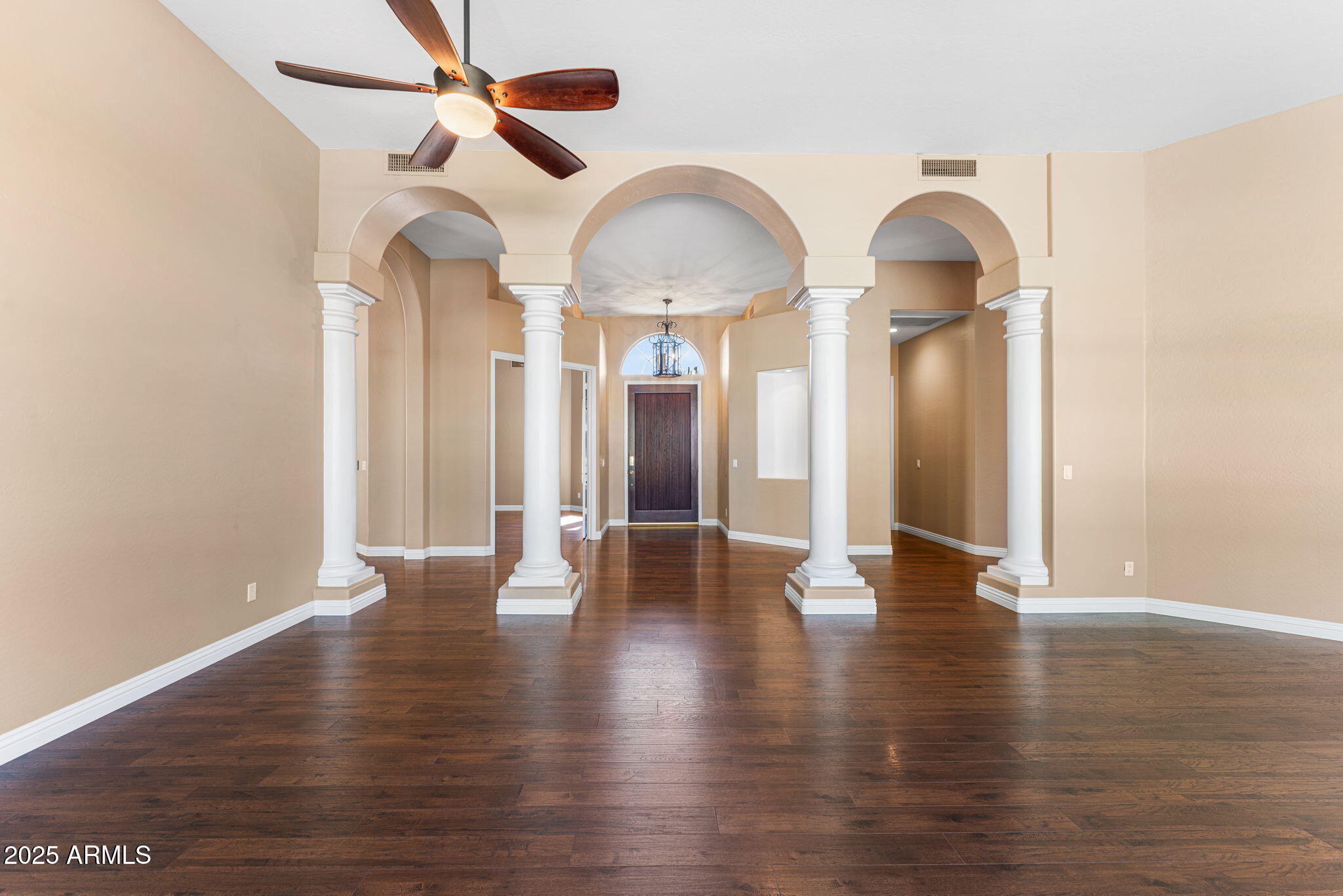 4410 East Robin Lane Phoenix, AZ 85050 - Photo 18 of 44 a view of a livingroom with wooden floor and a ceiling fan