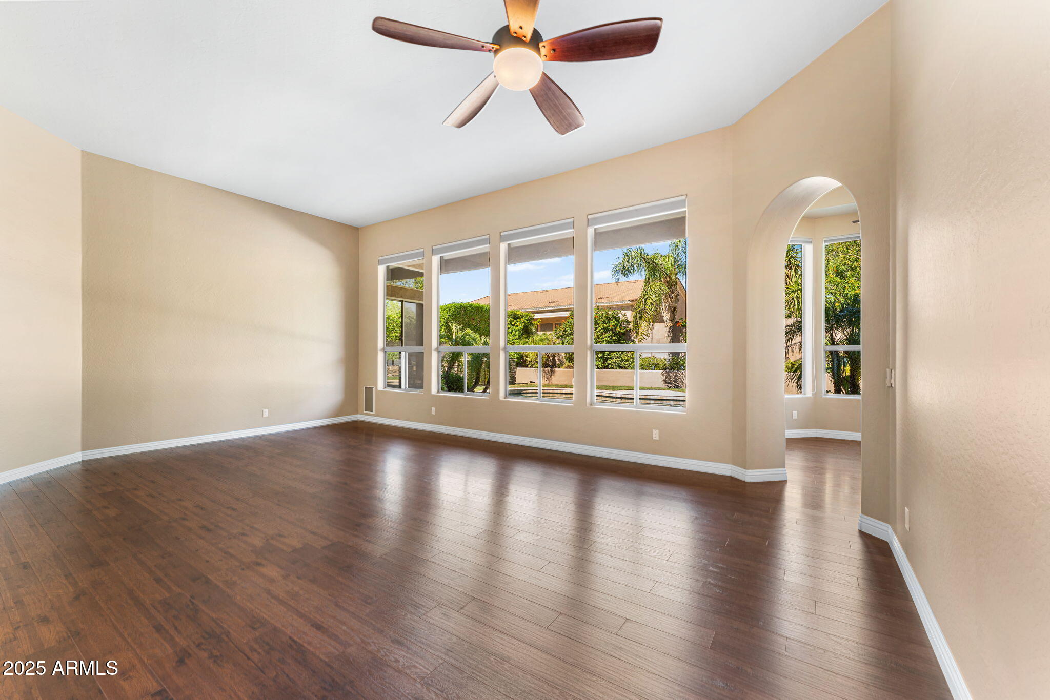 4410 East Robin Lane Phoenix, AZ 85050 - Photo 19 of 44 a view of an empty room with wooden floor and a window