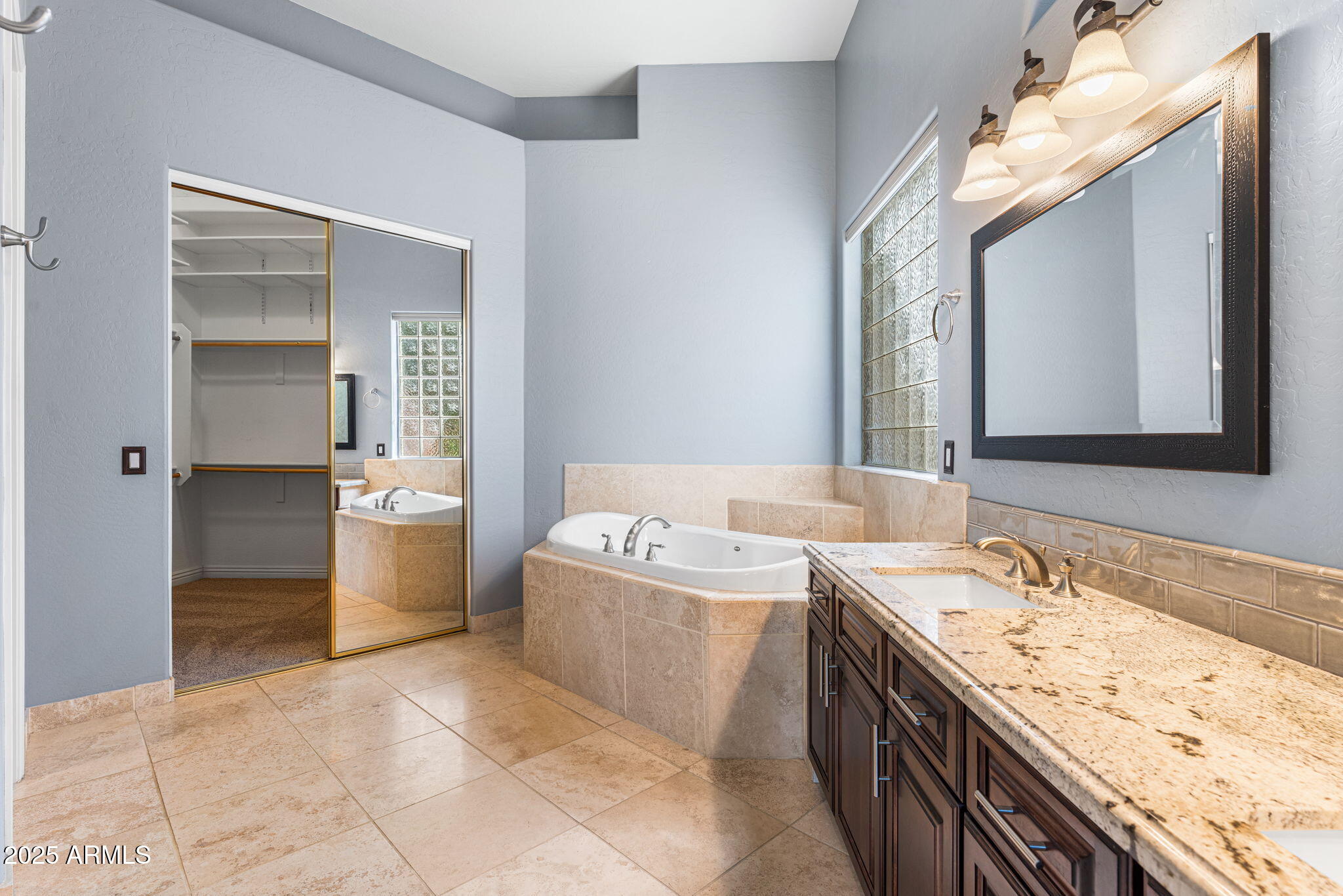 4410 East Robin Lane Phoenix, AZ 85050 - Photo 22 of 44 a bathroom with a bathtub sink and mirror