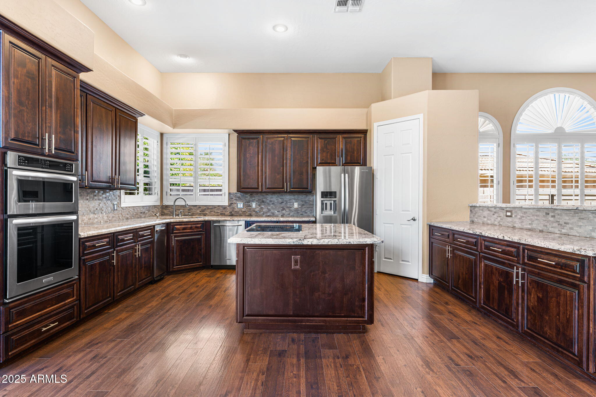 4410 East Robin Lane Phoenix, AZ 85050 - Photo 2 of 44 a large kitchen with stainless steel appliances and wooden cabinets
