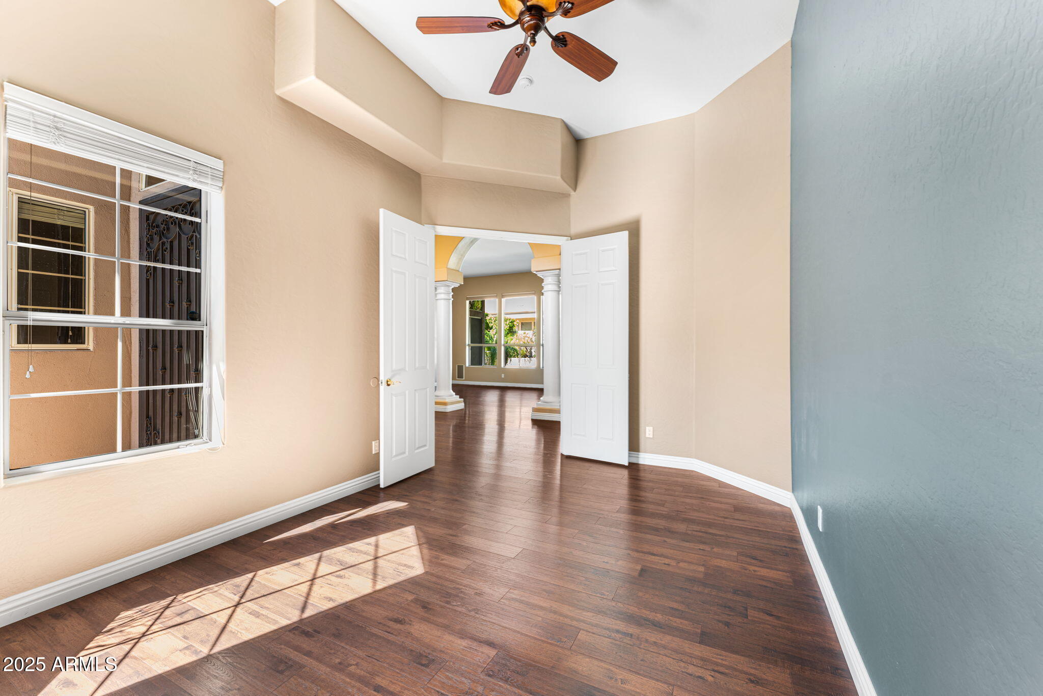4410 East Robin Lane Phoenix, AZ 85050 - Photo 30 of 44 a view of an empty room with a window and wooden floor