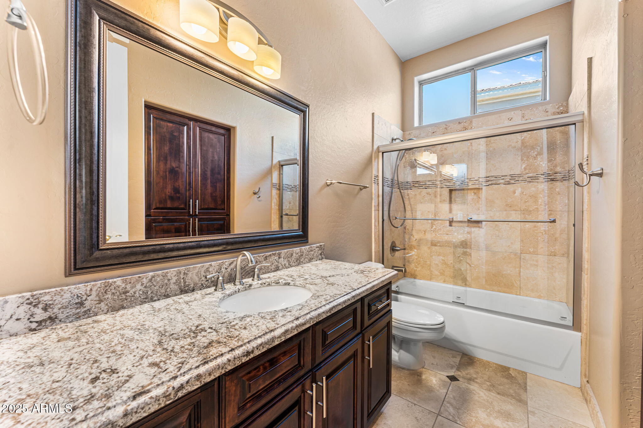 4410 East Robin Lane Phoenix, AZ 85050 - Photo 31 of 44 a bathroom with a granite countertop sink a toilet and shower