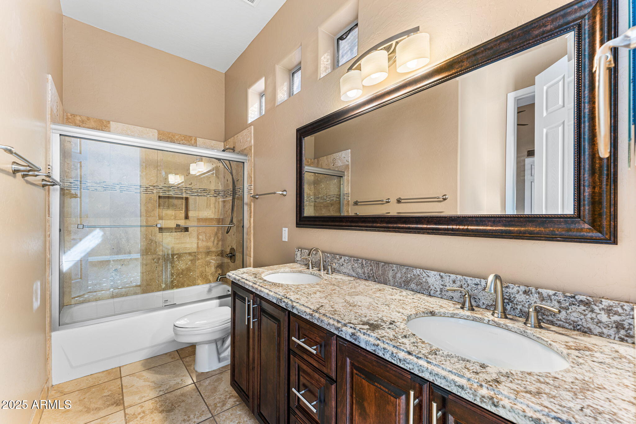 4410 East Robin Lane Phoenix, AZ 85050 - Photo 34 of 44 a bathroom with a granite countertop double vanity sink and a mirror