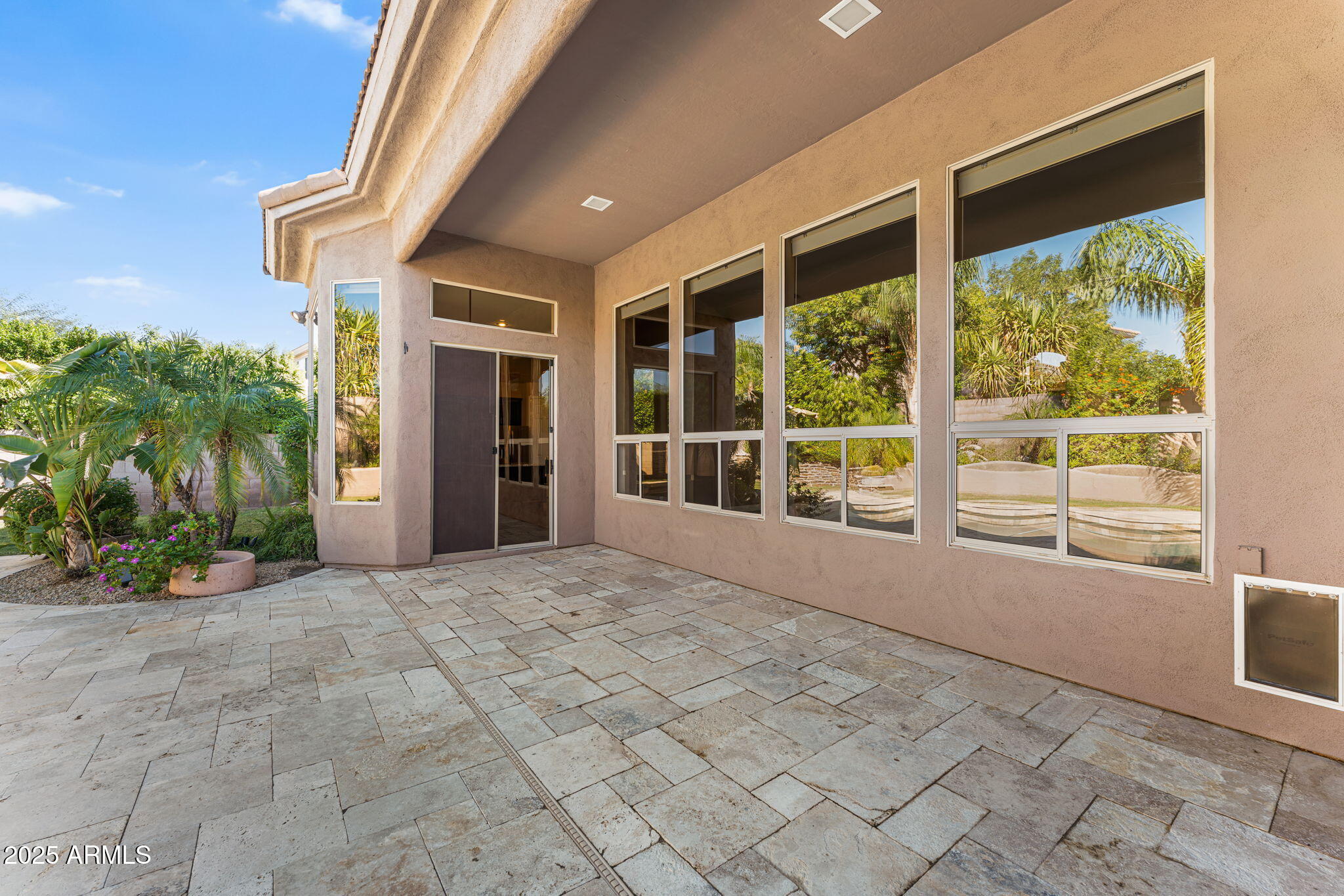 4410 East Robin Lane Phoenix, AZ 85050 - Photo 37 of 44 a view of an empty room with a floor to ceiling window and potted plants