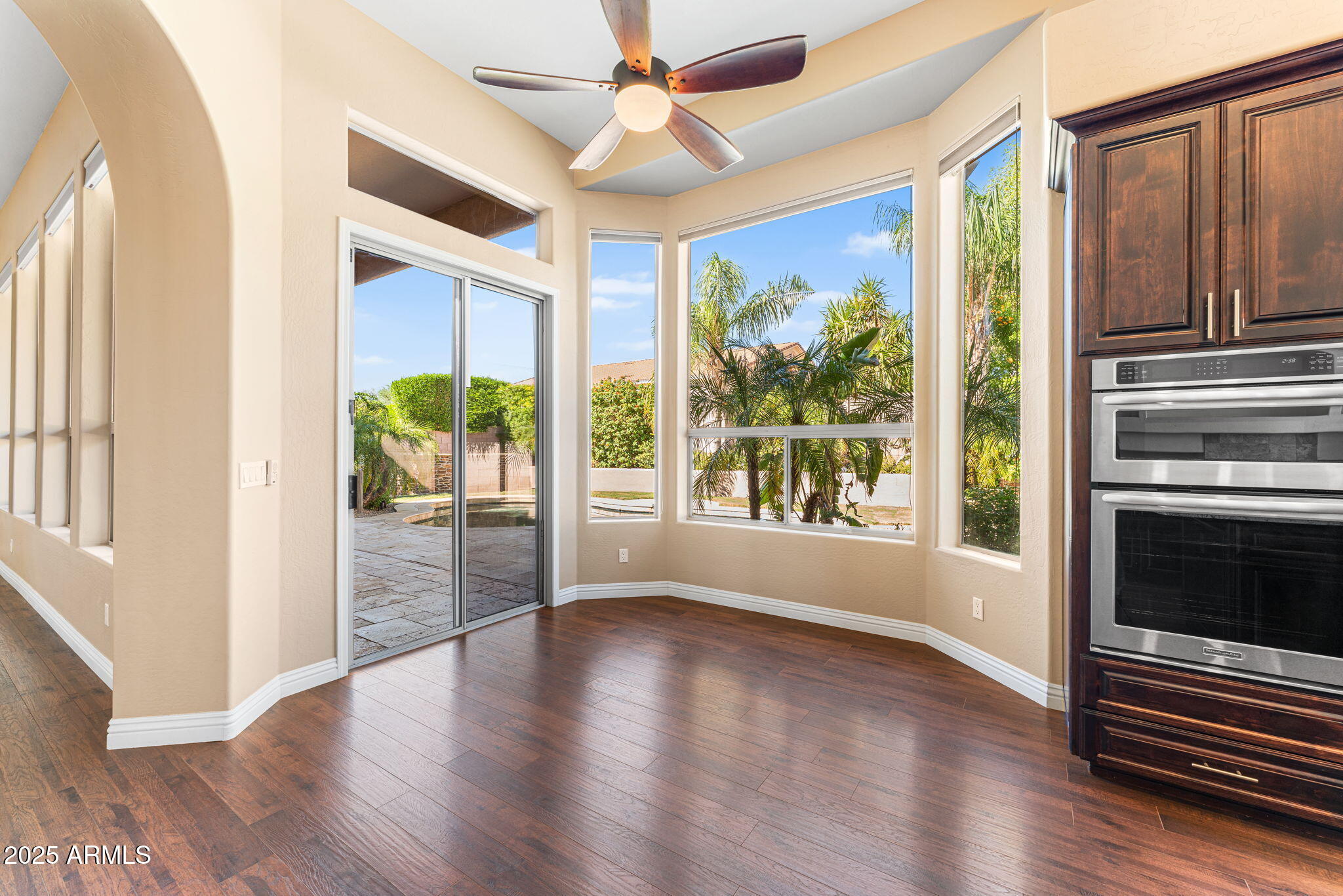 4410 East Robin Lane Phoenix, AZ 85050 - Photo 3 of 44 a view of an empty room with wooden floor and a window