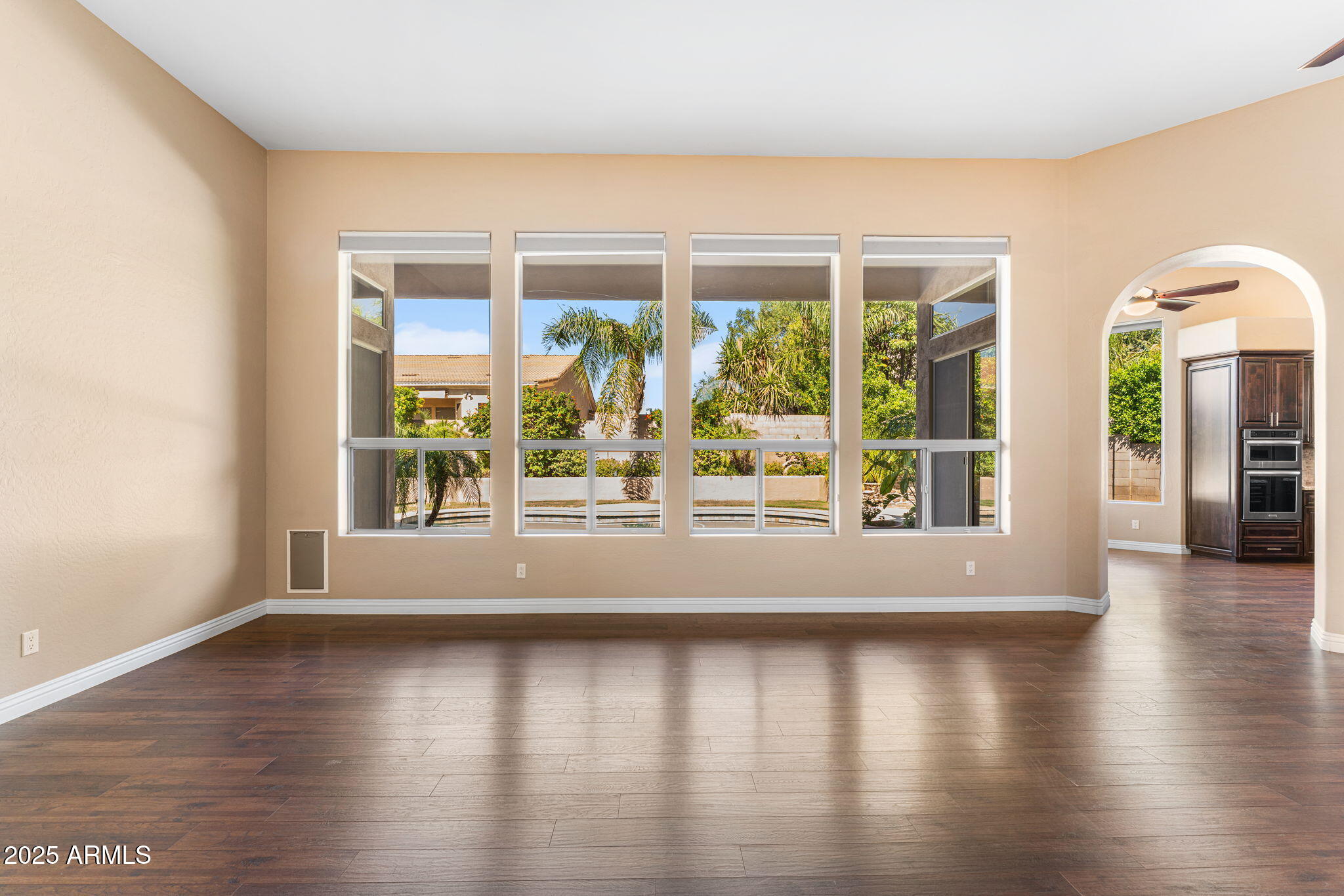 4410 East Robin Lane Phoenix, AZ 85050 - Photo 7 of 44 a view of empty room with wooden floor and fan