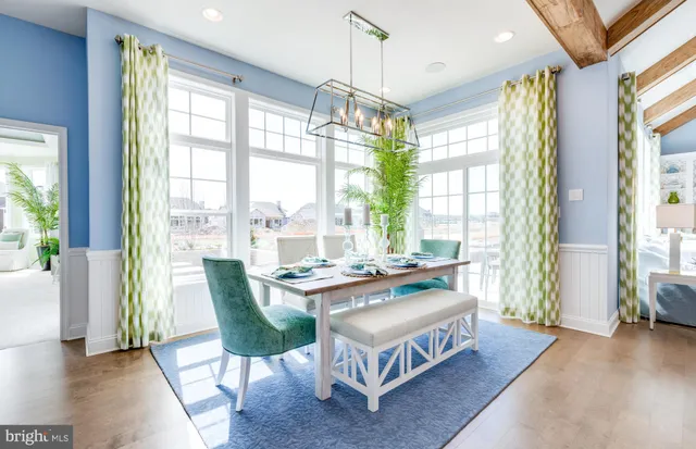 a bedroom with furniture and a large window