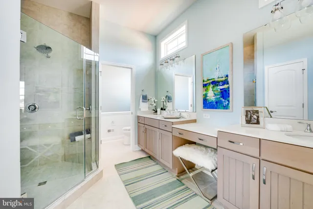 a bedroom with a bed mirror and a large window