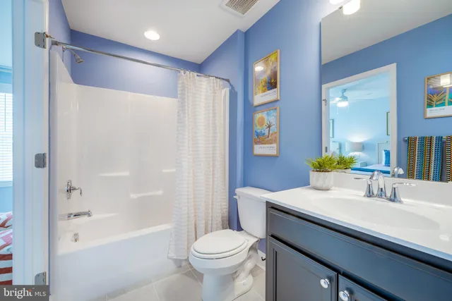 a bedroom with two beds and painting on the wall