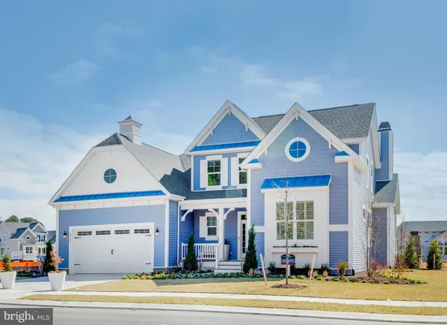 a view of a big house with a big yard and large tree