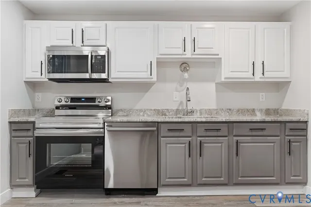 a kitchen with granite countertop a stove and a sink