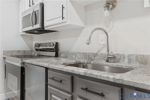 a kitchen with a sink and a stove