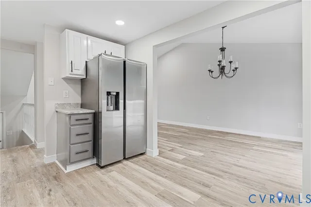 a view of a kitchen with a sink and refrigerator