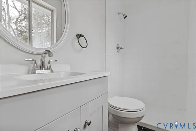 a bathroom with a sink a toilet and mirror