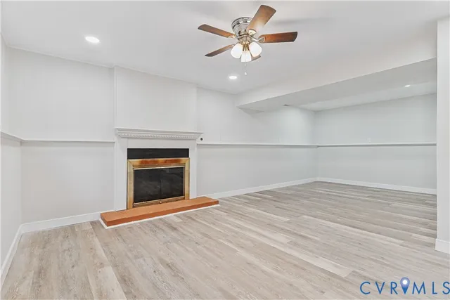 wooden floor in an empty room with a fireplace