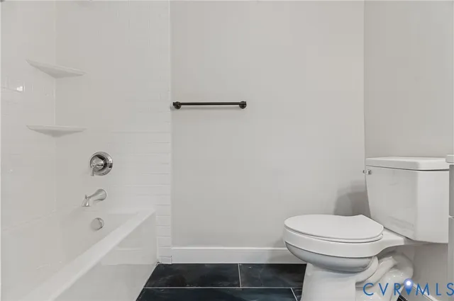 a bathroom with a toilet and a bathtub