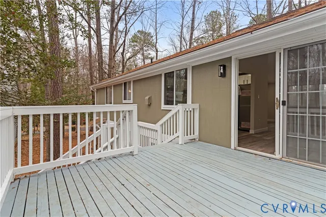 a view of a house with a wooden deck