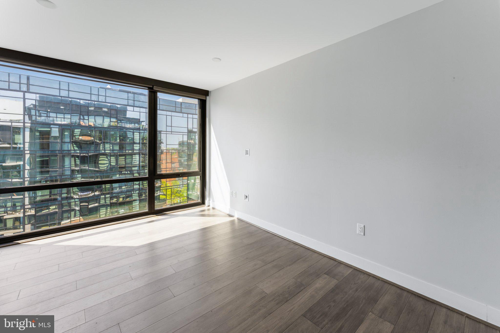 1300 4th Street Southeast, Unit 902 Washington, DC 20003 - Photo 16 of 42 wooden floor in an empty room with a window