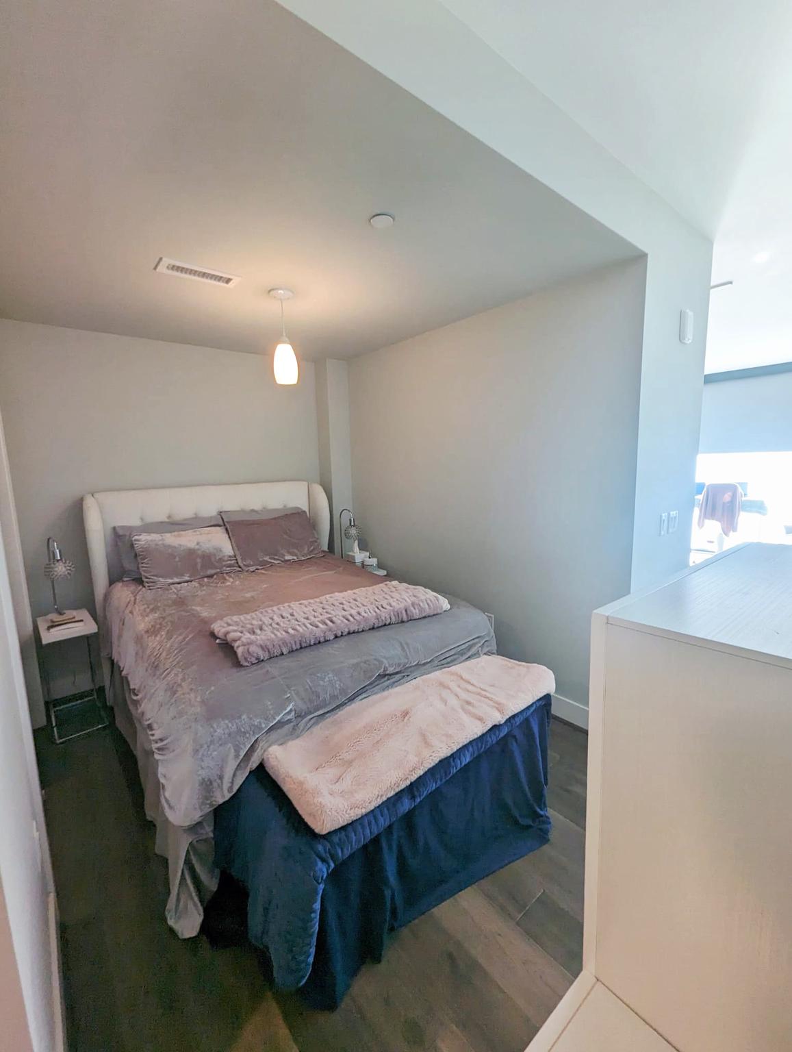 1300 4th Street Southeast, Unit 902 Washington, DC 20003 - Photo 17 of 42 a bedroom with a bed and a table in it