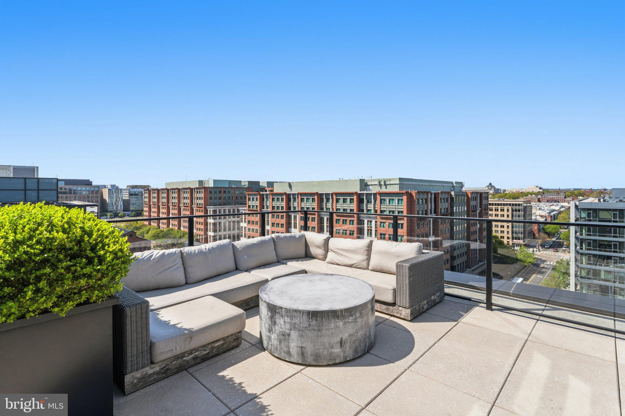 1300 4th Street Southeast, Unit 902 Washington, DC 20003 - Photo 27 of 42 a roof deck with couches and potted plants