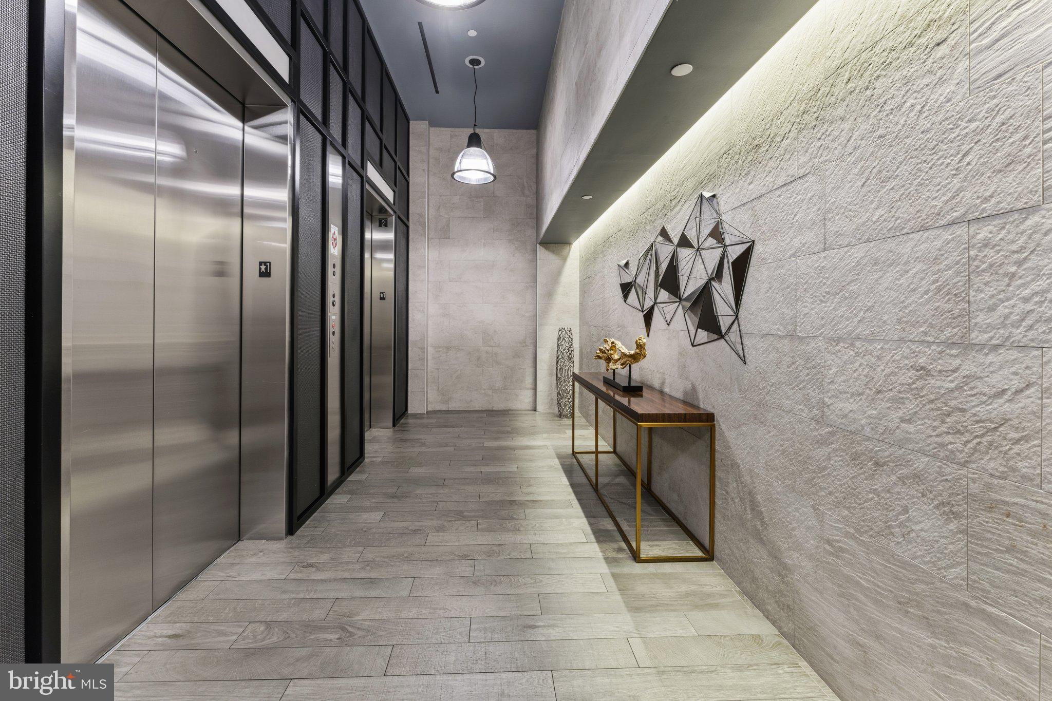 1300 4th Street Southeast, Unit 902 Washington, DC 20003 - Photo 53 of 68 Sleek modern corridor with elevators.